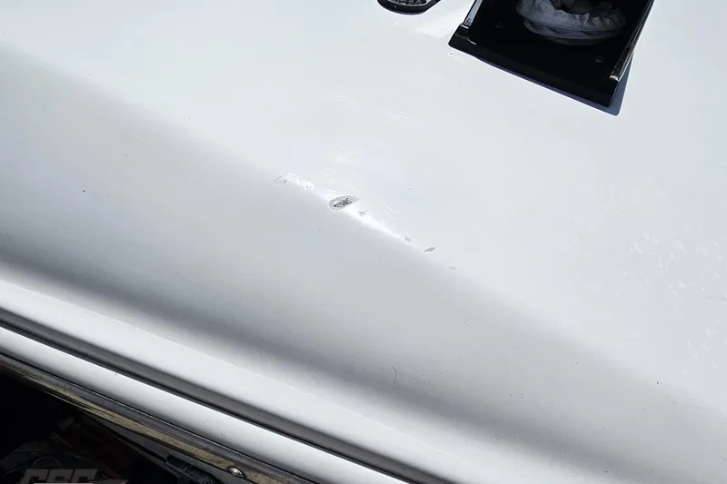Slide: The Image of Close-up of a 1997 Donzi 18 Classic boat with visible surface scratches. - 52