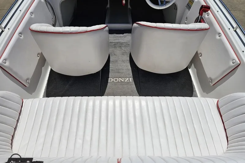 Slide: The Image of 1997 Donzi 18 Classic boat interior with white seating and red trim accents. - 55