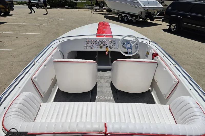 Slide: The Image of 1997 Donzi 18 Classic boat interior with white seating and red accents. - 56