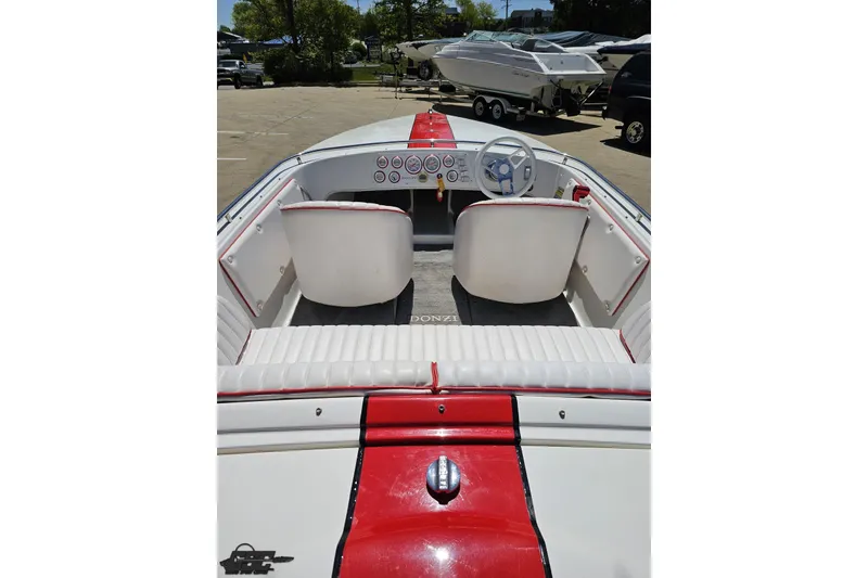 Slide: The Image of 1997 Donzi 18 Classic boat interior with red and white seating and dashboard. - 57