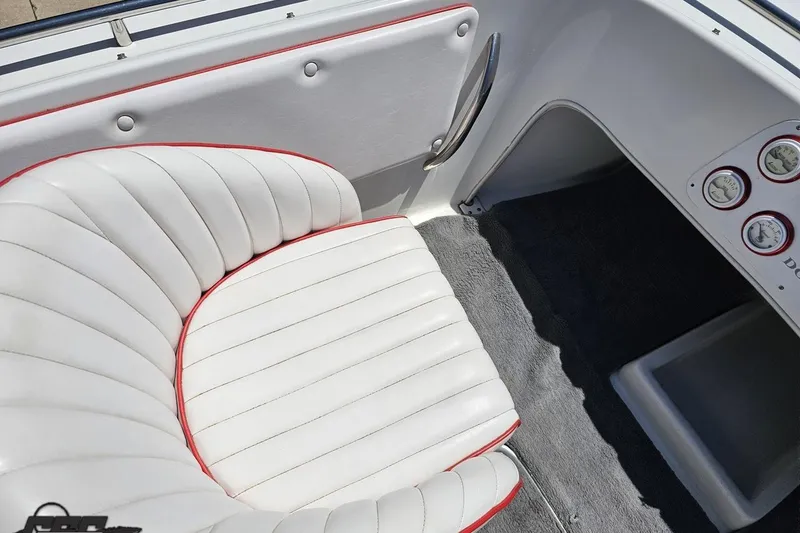 Slide: The Image of Interior of a 1997 Donzi 18 Classic boat with white and red-trimmed seating. - 61
