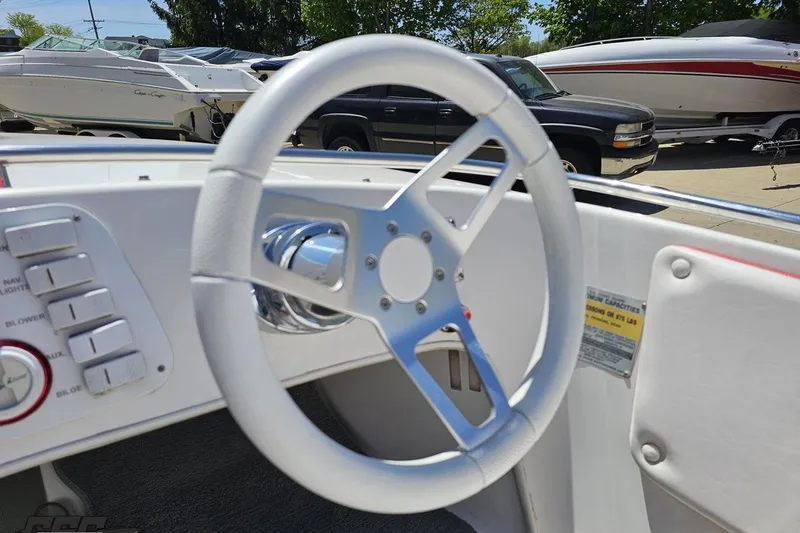 Slide: The Image of Steering wheel of a 1997 Donzi 18 Classic boat, with dashboard controls visible. - 66