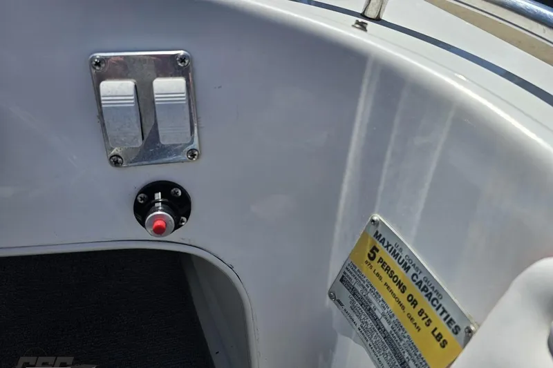 Slide: The Image of 1997 Donzi 18 Classic boat interior with switches and capacity label. - 68