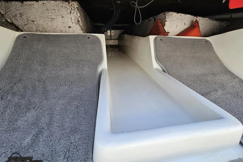 Slide: The Image of Interior view of a 1997 Donzi 18 Classic boat with gray carpeted flooring. - 70
