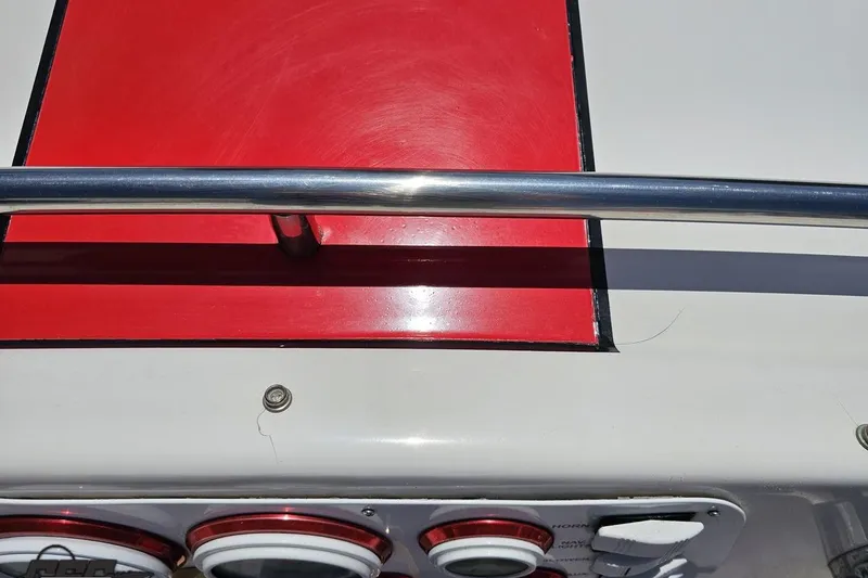 Slide: The Image of 1997 Donzi 18 Classic boat dashboard with red panel and chrome railing. - 71