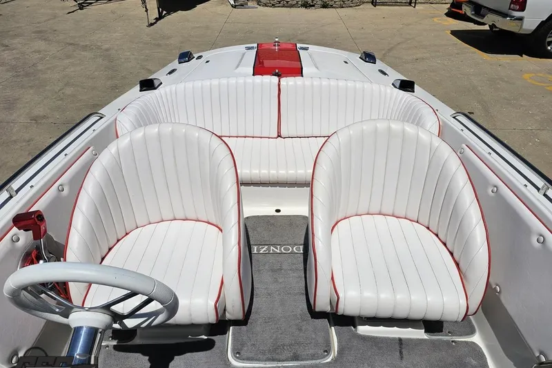 Slide: The Image of 1997 Donzi 18 Classic boat interior with white and red-trimmed seating. - 73