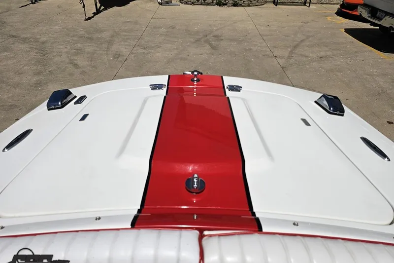 Slide: The Image of 1997 Donzi 18 Classic boat with red and white deck, parked on concrete. - 75
