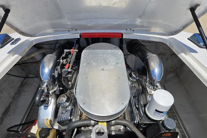 Slide: The Image of Engine compartment of a 1997 Donzi 18 Classic boat, showcasing chrome components. - 78