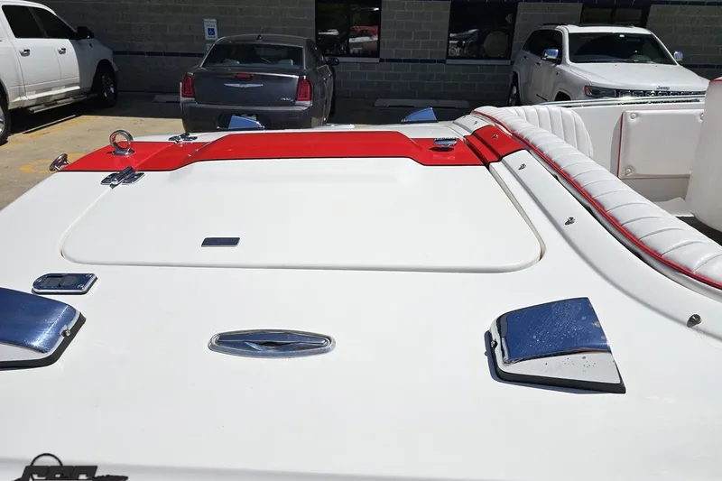 Slide: The Image of 1997 Donzi 18 Classic boat with white and red upholstery, parked in a lot. - 9