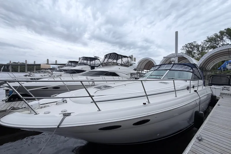 Slide: The Image of 2001 Sea Ray 380 Sundancer docked at marina under cloudy sky. - 1
