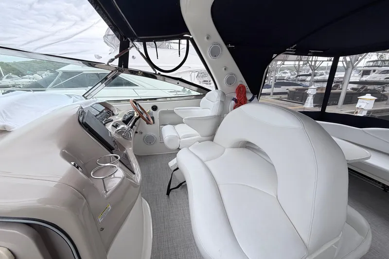 Slide: The Image of 2001 Sea Ray 380 Sundancer cockpit with white seating and modern helm controls. - 12