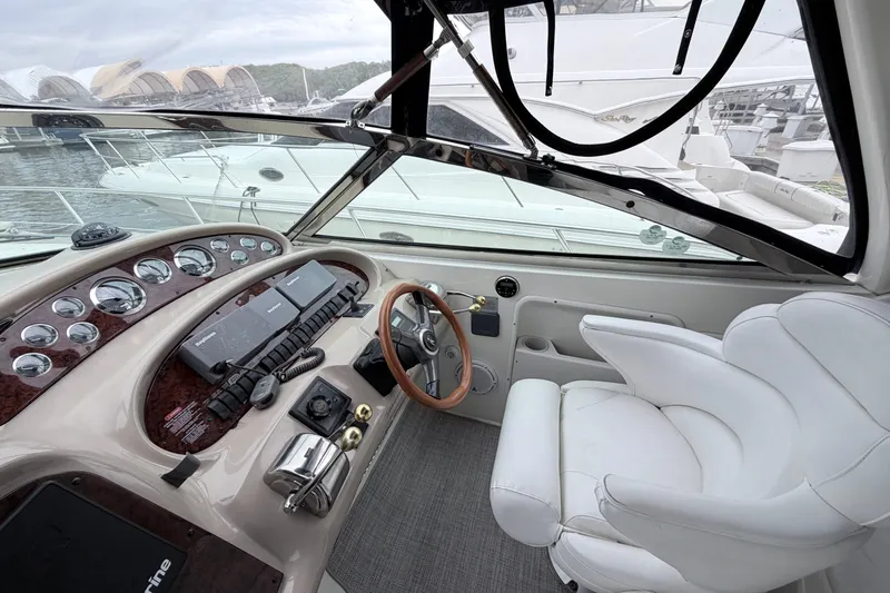 Slide: The Image of Cockpit of 2001 Sea Ray 380 Sundancer with steering wheel and control panel. - 13