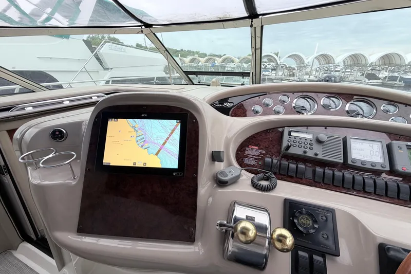 Slide: The Image of Helm of 2001 Sea Ray 380 Sundancer with navigation screen and controls. - 16