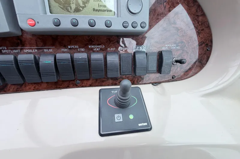 Slide: The Image of Control panel of a 2001 Sea Ray 380 Sundancer boat with switches and joystick. - 18