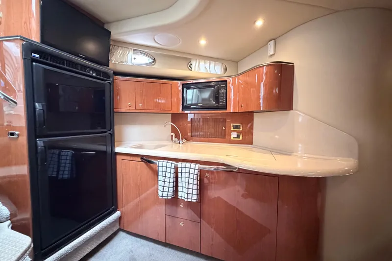 Slide: The Image of Luxurious kitchen interior of 2001 Sea Ray 380 Sundancer yacht with modern amenities. - 22