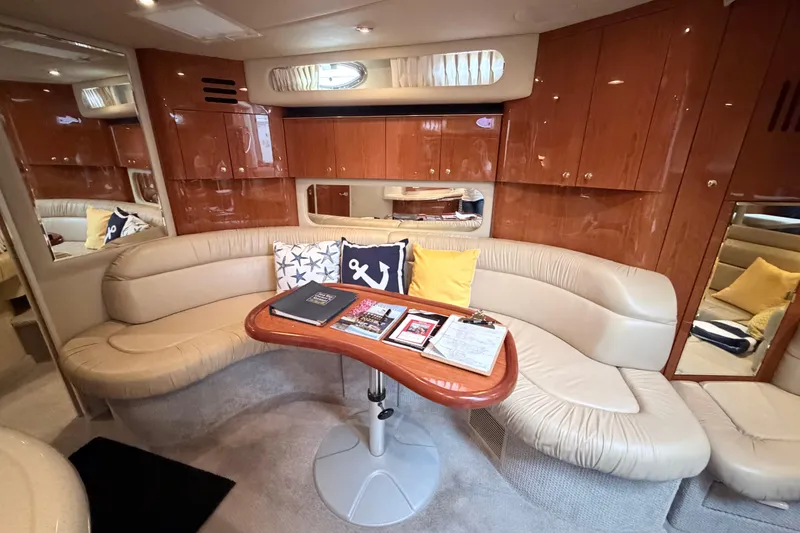Slide: The Image of Luxurious interior of 2001 Sea Ray 380 Sundancer yacht with plush seating and wooden cabinetry. - 24