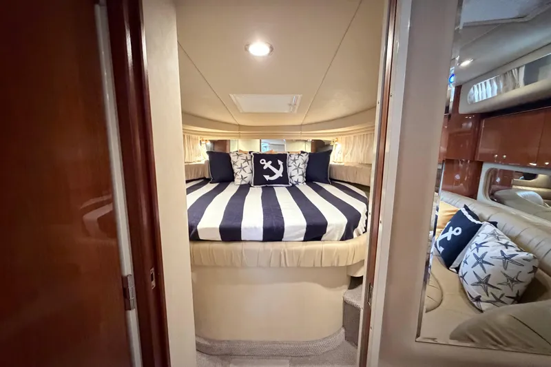 Slide: The Image of Luxurious 2001 Sea Ray 380 Sundancer cabin with nautical-themed bedding and cozy interior. - 27
