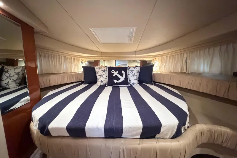 Slide: The Image of Luxurious cabin interior of 2001 Sea Ray 380 Sundancer with nautical-themed bedding. - 28