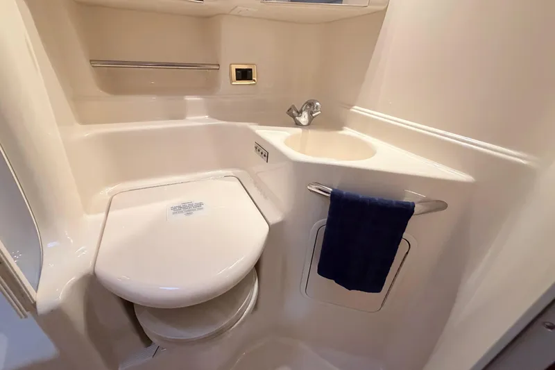 Slide: The Image of 2001 Sea Ray 380 Sundancer bathroom with toilet, sink, and towel rack. - 34