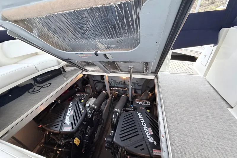 Slide: The Image of Engine compartment of a 2001 Sea Ray 380 Sundancer with Mercury engines visible. - 38