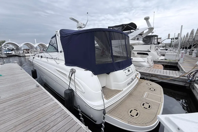 Slide: The Image of 2001 Sea Ray 380 Sundancer docked at marina, featuring sleek design and covered cockpit. - 4