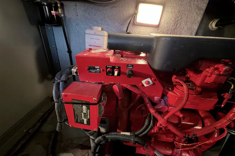 Slide: The Image of Engine compartment of a 2001 Sea Ray 380 Sundancer with red mechanical components. - 48