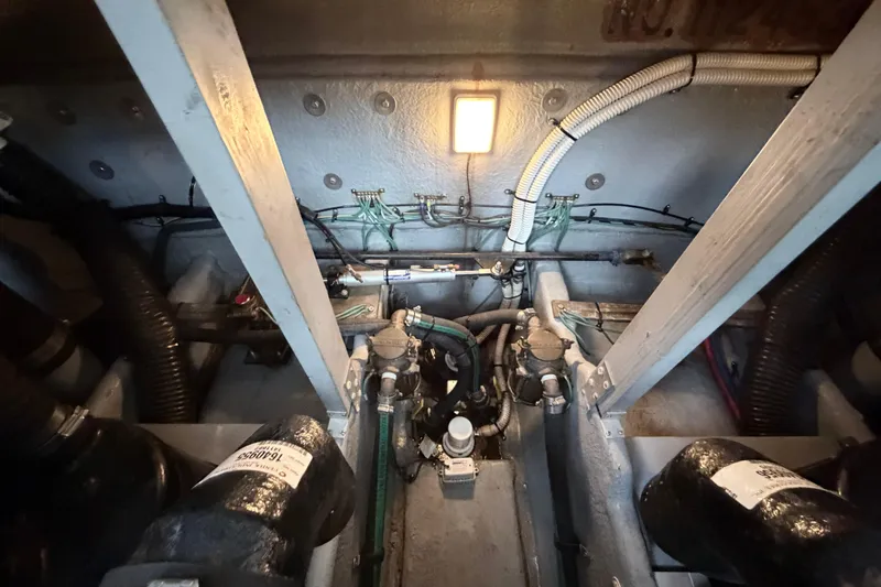 Slide: The Image of Engine compartment of a 2001 Sea Ray 380 Sundancer boat, showing mechanical components. - 52