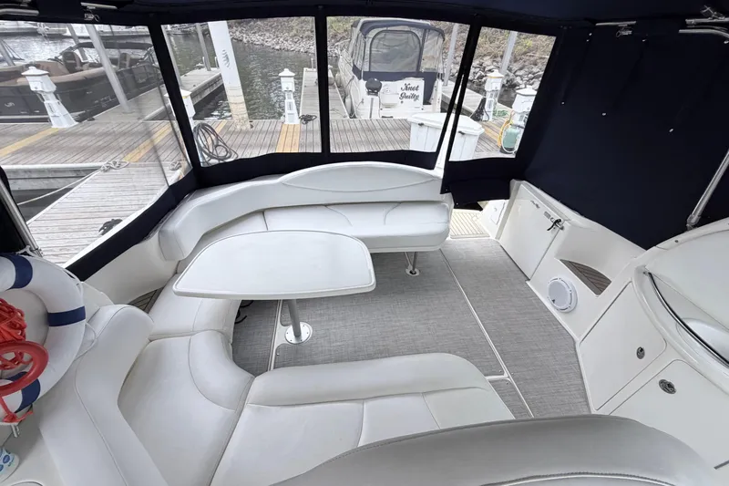 Slide: The Image of Interior of a 2001 Sea Ray 380 Sundancer yacht with white seating and table. - 8