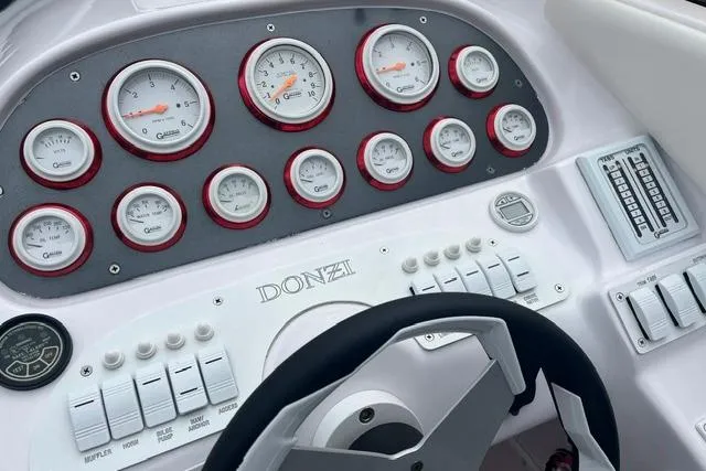 Slide: The Image of Dashboard of a 2000 Donzi 33 ZX boat with gauges and controls. - 10