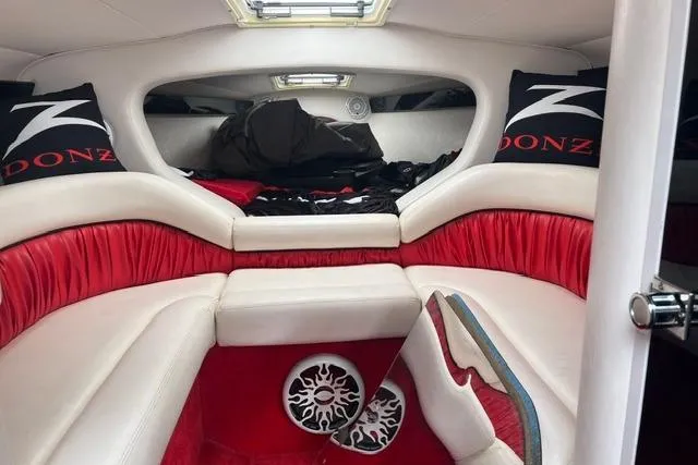 Slide: The Image of Interior of a 2000 Donzi 33 ZX boat with red and white seating. - 13