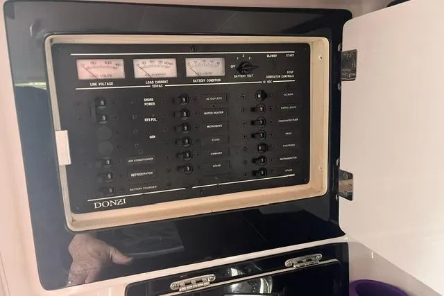 Slide: The Image of Control panel of a 2000 Donzi 33 ZX boat, featuring various switches and gauges. - 15