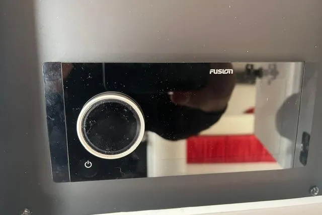 Slide: The Image of Fusion audio control panel on a 2000 Donzi 33 ZX boat dashboard. - 17