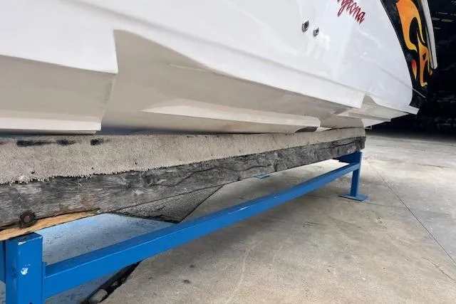 Slide: The Image of 2000 Donzi 33 ZX boat on a blue trailer, showcasing hull design and vibrant graphics. - 19