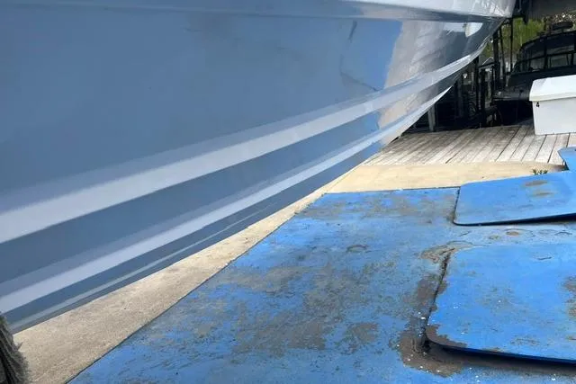 Slide: The Image of 2000 Donzi 33 ZX boat hull on blue dock surface. - 20
