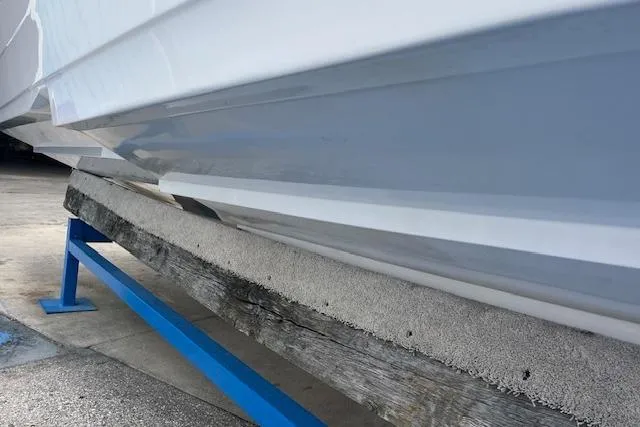 Slide: The Image of 2000 Donzi 33 ZX boat hull on a support stand, showcasing sleek design and craftsmanship. - 21