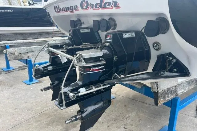 Slide: The Image of 2000 Donzi 33 ZX boat with Mercury outboard engines on a dock. - 4