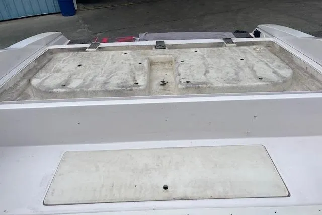 Slide: The Image of 2000 Donzi 33 ZX boat deck, showing weathered surface and storage compartment. - 5