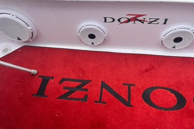 Slide: The Image of Red carpet on a 2000 Donzi 33 ZX boat with speakers and branding. - 6
