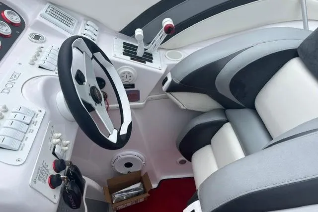Slide: The Image of Cockpit of a 2000 Donzi 33 ZX boat with steering wheel and controls. - 9