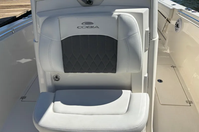 Slide: The Image of 2023 Cobia 301 Center Console boat seat with logo and diamond stitching. - 21