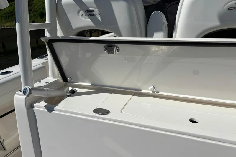 Slide: The Image of 2023 Cobia 301 Center Console boat interior detail with open storage compartment. - 23