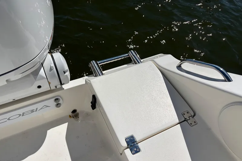 Slide: The Image of 2023 Cobia 301 Center Console boat with sleek deck and motor detail. - 25
