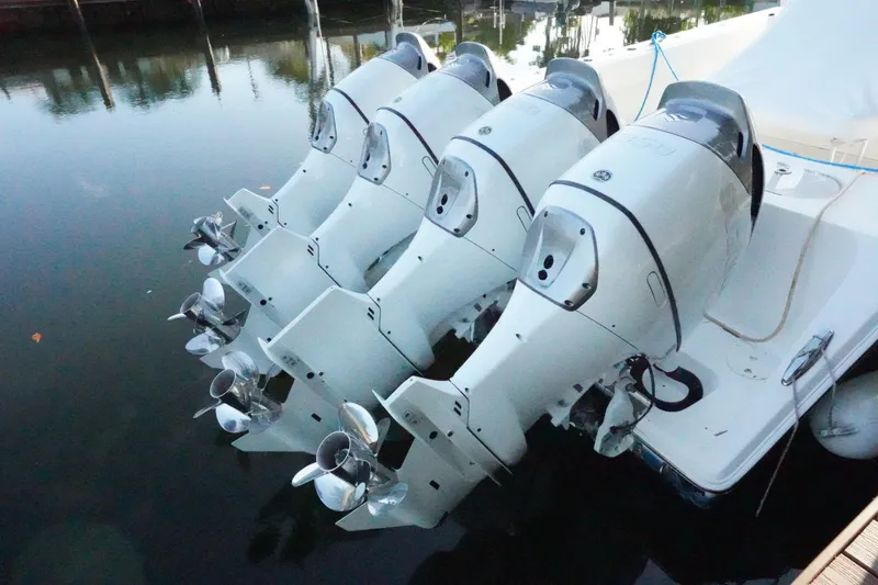The Image of 2014 SeaHunter 45 Tournament boat on calm water, surrounded by lush greenery and waterfront homes. - 0