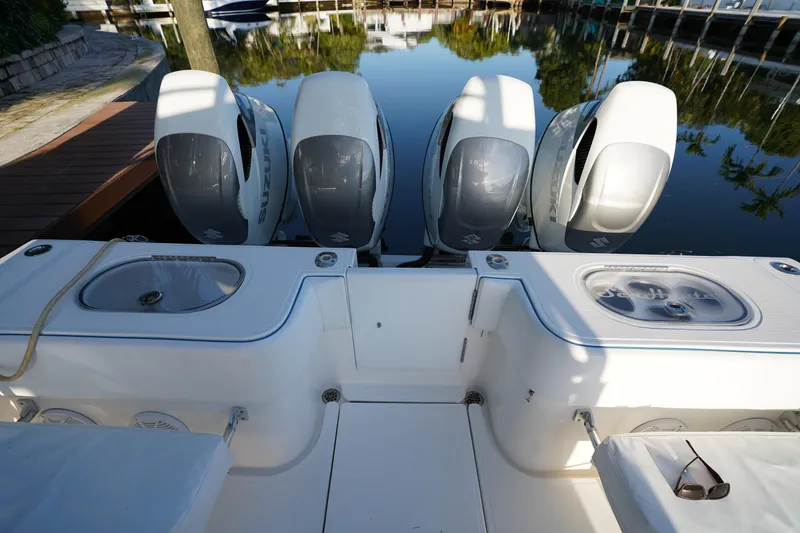 Slide: The Image of 2014 SeaHunter 45 Tournament boat with four powerful outboard engines docked by the water. - 10