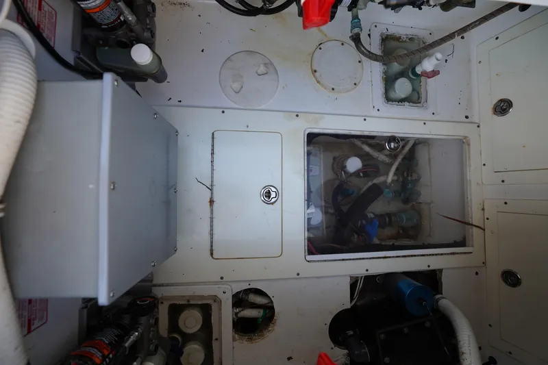 Slide: The Image of Engine compartment of a 2014 SeaHunter 45 Tournament boat, showcasing mechanical components. - 12