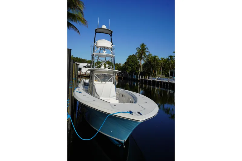 Slide: The Image of 2014 SeaHunter 45 Tournament boat docked on a calm, sunny day with palm trees. - 17