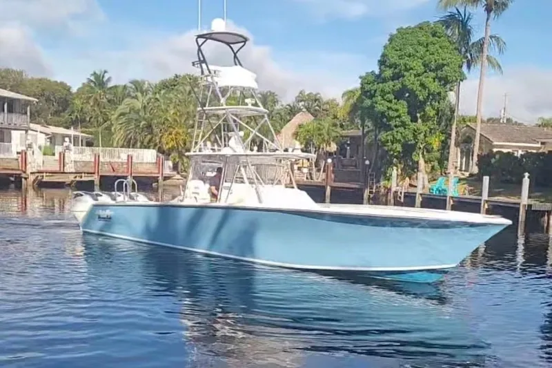 Slide: The Image of 2014 SeaHunter 45 Tournament boat on calm water near a tropical shoreline. - 20