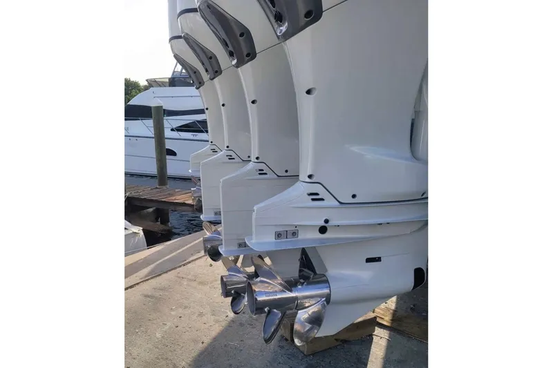 Slide: The Image of Outboard motors of a 2014 SeaHunter 45 Tournament boat docked at a marina. - 22