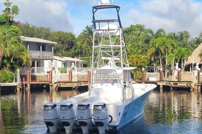 Slide: The Image of 2014 SeaHunter 45 Tournament boat with four engines docked near tropical waterfront homes. - 23