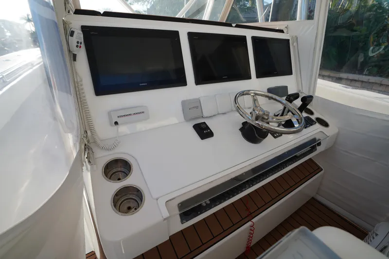 Slide: The Image of Helm of 2014 SeaHunter 45 Tournament boat with navigation screens and steering wheel. - 5